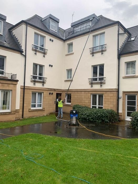 High-level gutter and roof cleaning at a residential building